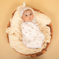 Load image into Gallery viewer, Match your baby’s outfit with our ultra-soft beanies, made snug enough to stay on all day. More than an accessory, they mimic the warmth of the womb and help regulate baby’s temperature. These beanies pair perfectly with our swaddles, gowns, bodysuits and bottoms.
